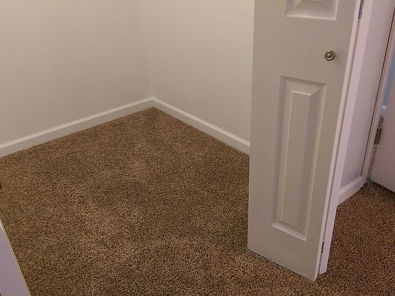 Walk in closet has enough space for multiple dressers and is