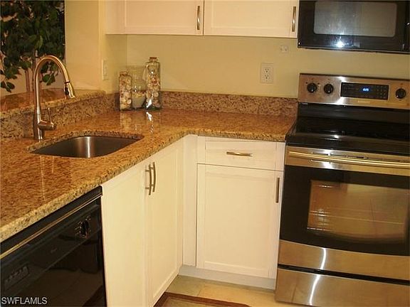 The updated kitchen includes refaced cabinets, granite counters and stainless appliances.
