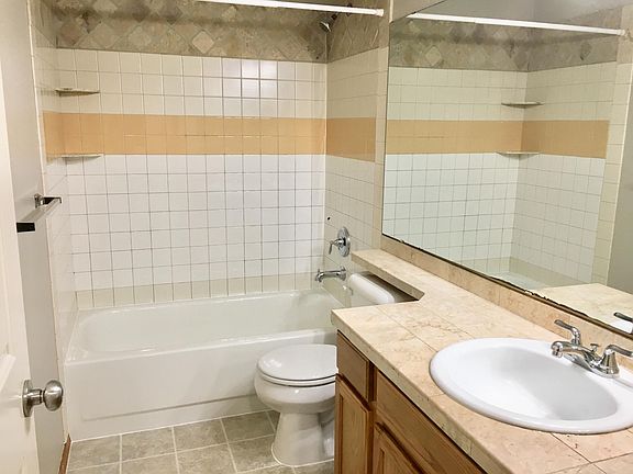 Bathroom with tile counter and tile surround