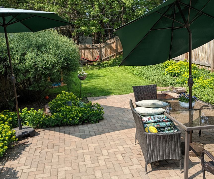 Fully fenced backyard with large patio that can fit a dining table for 6, additional seating if you choose, and a grill.