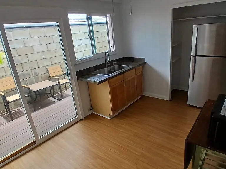 Kitchen area with full size fridge and microwave.