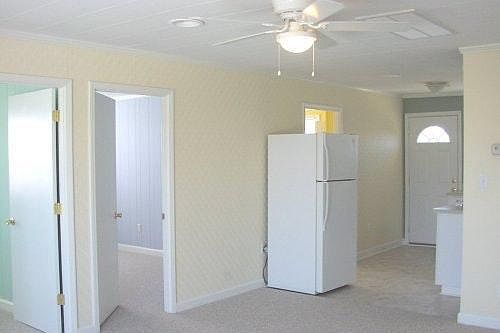 Living and kitchen showing bedroom doors.