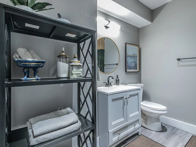 Stylish bathroom with a modern vanity and ample guest storage.
