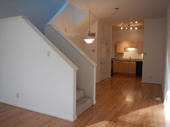 stairs with skylight and kitchen