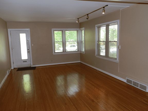 living room with hardwood floors and new windows