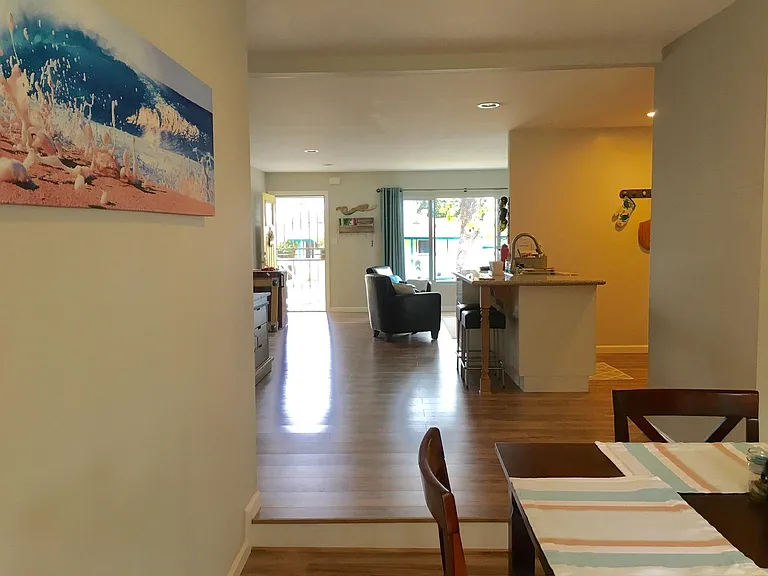 View from back of house looking through kitchen area towards front door and front picture window