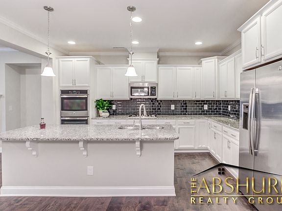 Luxurious open concept kitchen w/ oversized island, granite countertops, SS appliances, 2 wall ovens