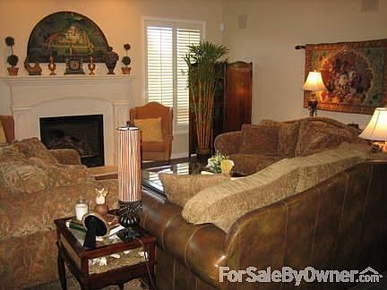Living Room : Warm color palatte with open floor plan and gas fireplace.
