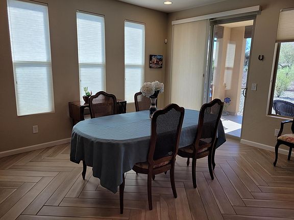 Dining area and access to back patio and yard with BBQ.