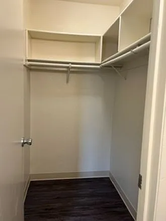 Master bedroom walk-in closet with storage cubbies