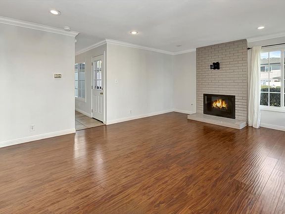 Bright living room with cozy fireplace.