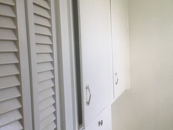 Closets across from vanity in the bathroom.