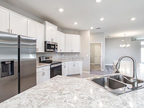 Spacious, open kitchen with walk-in pantry shown with optional wrap-around, counter-height breakfas