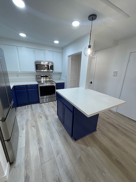large kitchen with center island with built in cabinetry in island