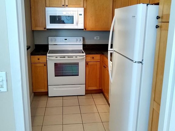 Kitchen with tile floor and newer appliances