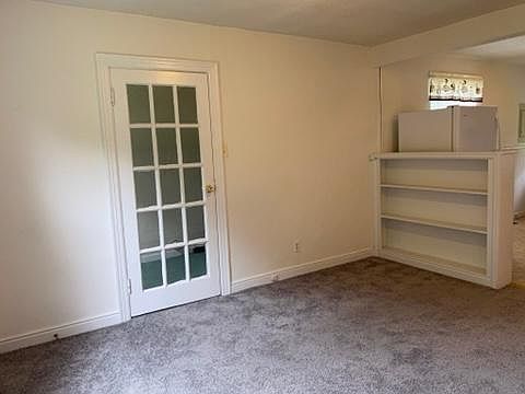 Living room with door to laundry room