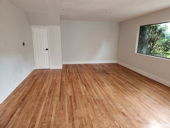 Large living room with a storage closet and real oak wood flooring that was refinished.
