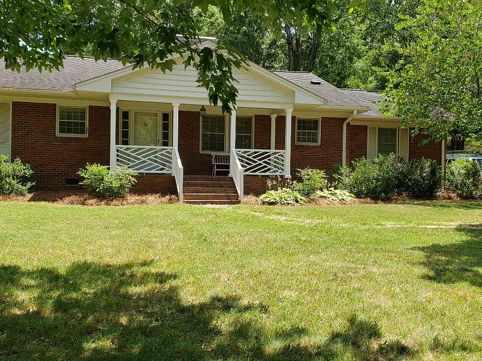 Single-level (2018 SF) brick home on 1/2 acre, with a large carport and deck.