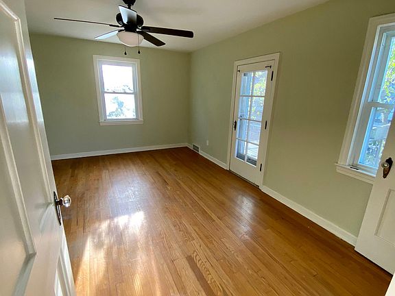 Master bedroom with ceiling fan and access to balcony