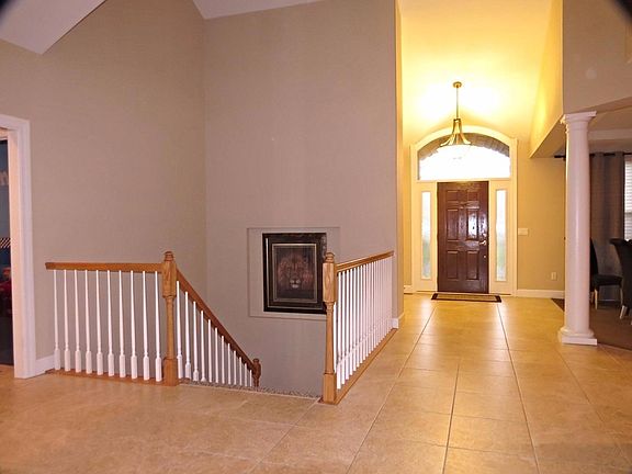 Gorgeous ceramic tile with open basement entrance vs closed off doors makes this home completely open and airy.