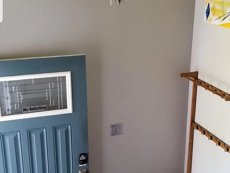 front door entryway with coat rack and shelves.