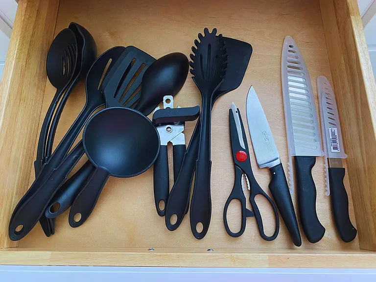Large knives, ladles, and utensils for serving and frying food.