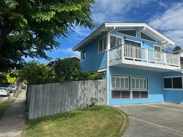 Street view of two story unit. Private entrance to fenced yard from sidewalk.