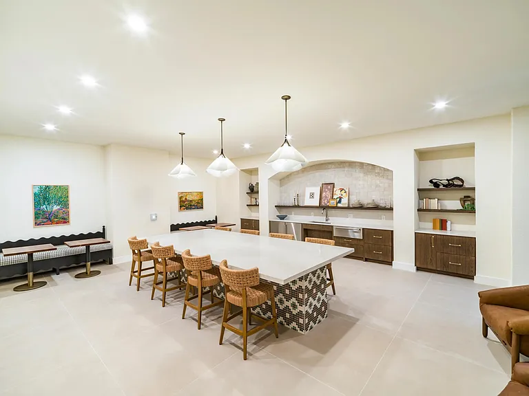 Host with ease in Modera Trailhead's stylish resident lounge, featuring a chef-inspired kitchen and spacious seating for gatherings.