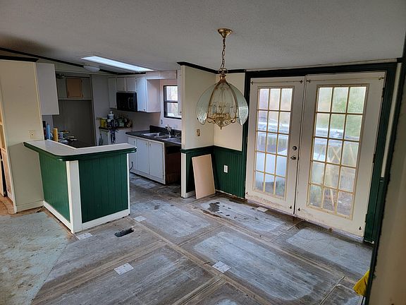 French Doors open up from the dining room to the XL back porch that overlooks a large pond (pond not included).