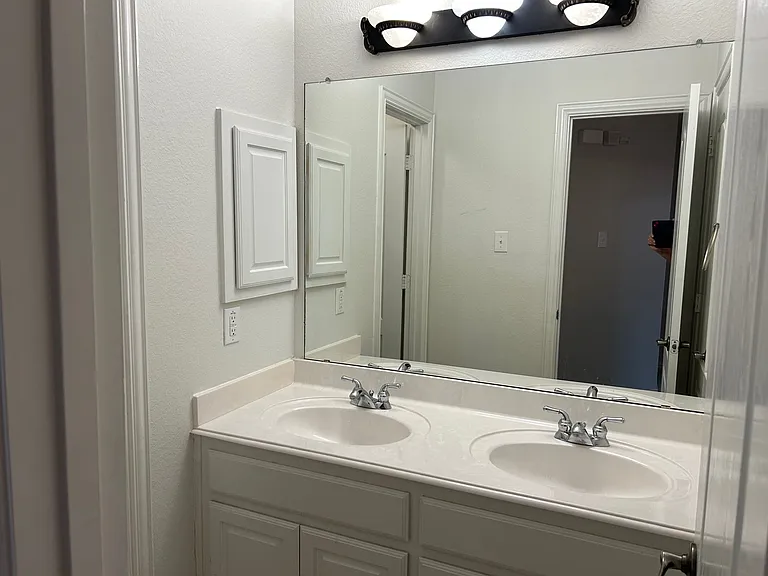 Hall bath with double sinks.