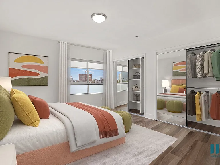 Spacious Bedroom with Two Mirrored Closets with Shelving