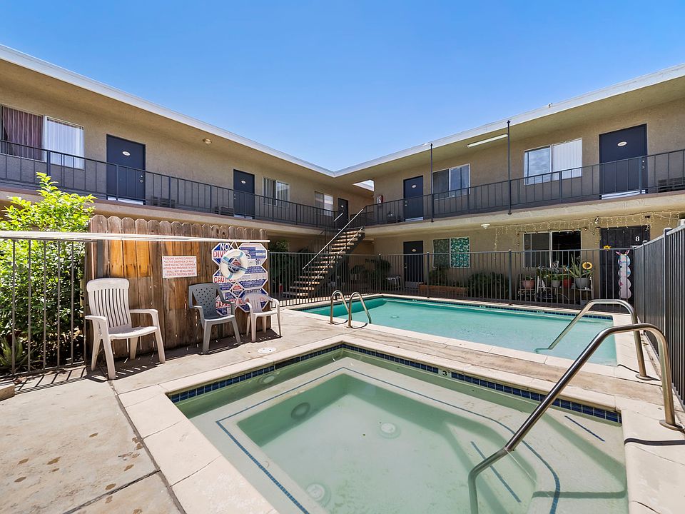 Beautifully maintained courtyard featuring a sparkling pool and inviting outdoor seating areas for residents to enjoy.