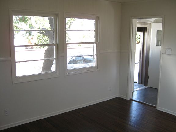 Living room towards front door and kitchen.