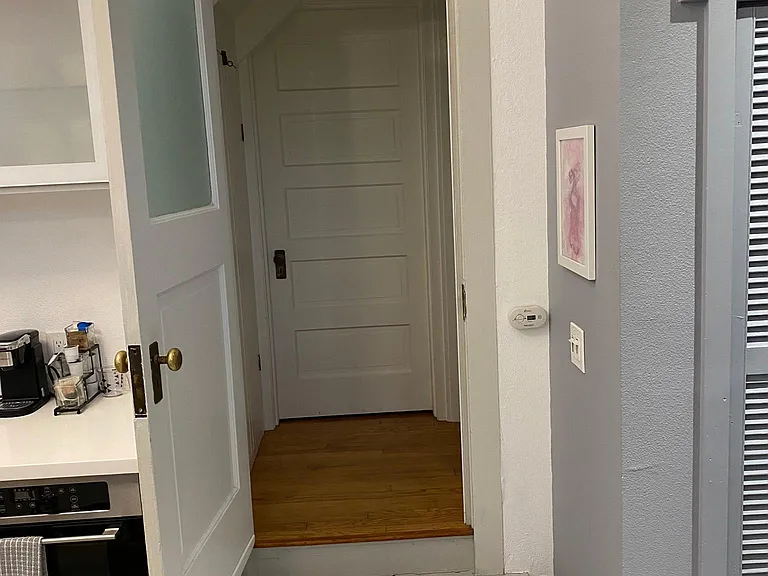 Kitchen looking into Shared Laundry Area- with good locking doors on both sides