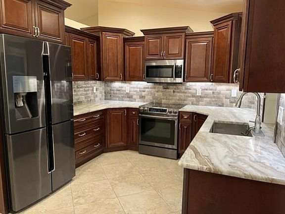 Kitchen with newer stainless appliances.