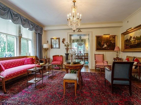 The living room overlooks the park and flows into the dining room