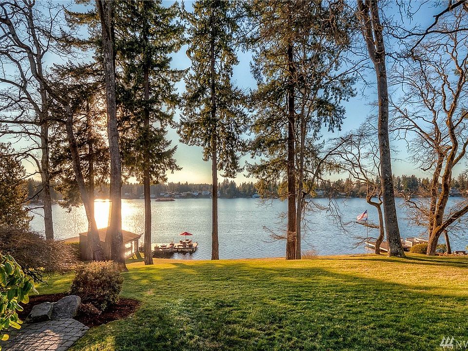 Western exposure affords incredible sunsets of the sunlight dancing on the water on this .76 acre Lake Steilacoom estate. 