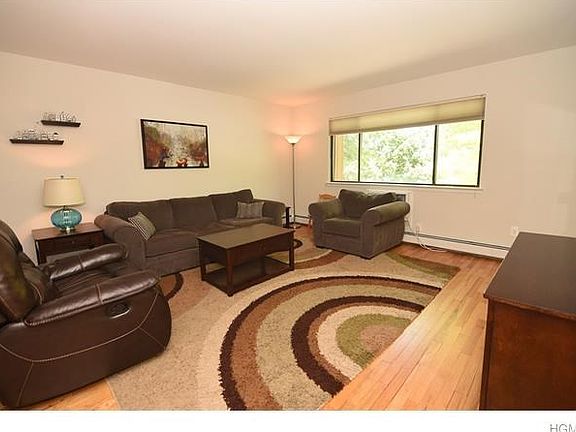 Sun filled living room with hardwood floors.