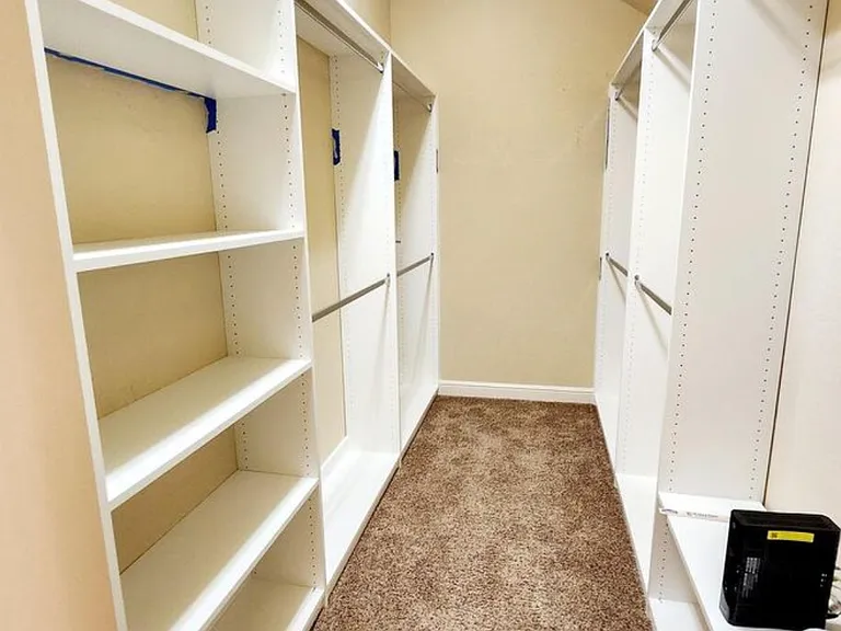 Master walk-in closet with built in shelving