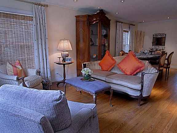 View of formal living and dining areas from front entry way.