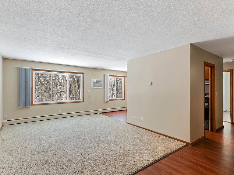 Living room with wall unit air conditioning