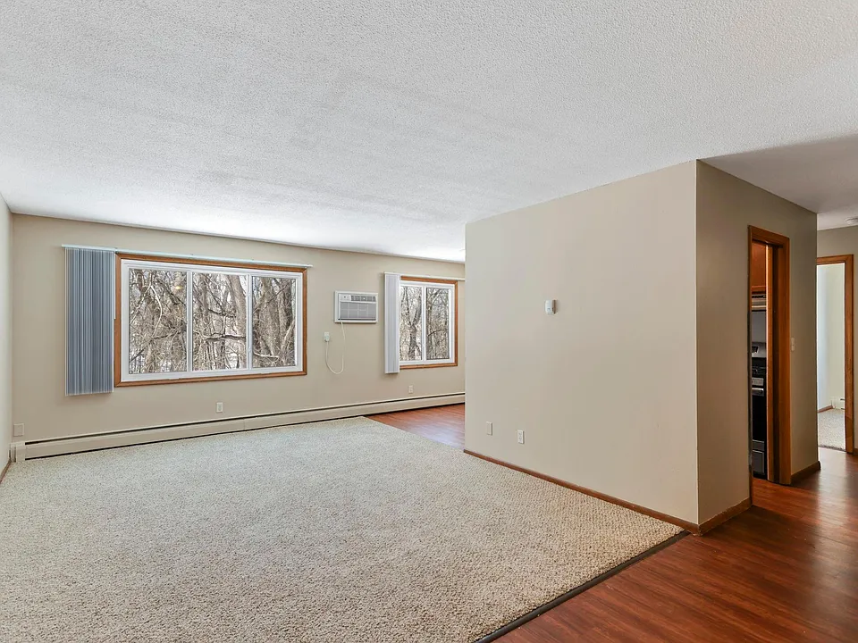 Living room with wall unit air conditioning