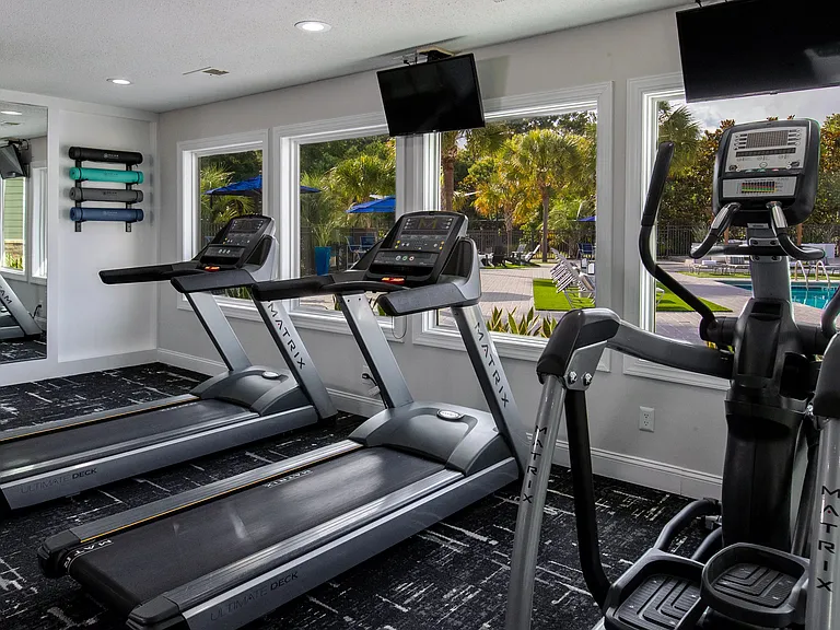 Our versatile cardio equipment features a view of our sparkling pool, offering a refreshing and inspiring workout experience.