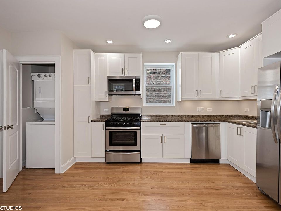 Full kitchen with stainless steel appliances including microwave and dishwasher. In-unit laundry.