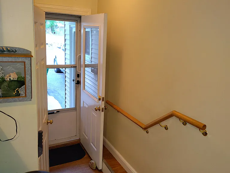 Side entrance to kitchen. Door to basement on the left.