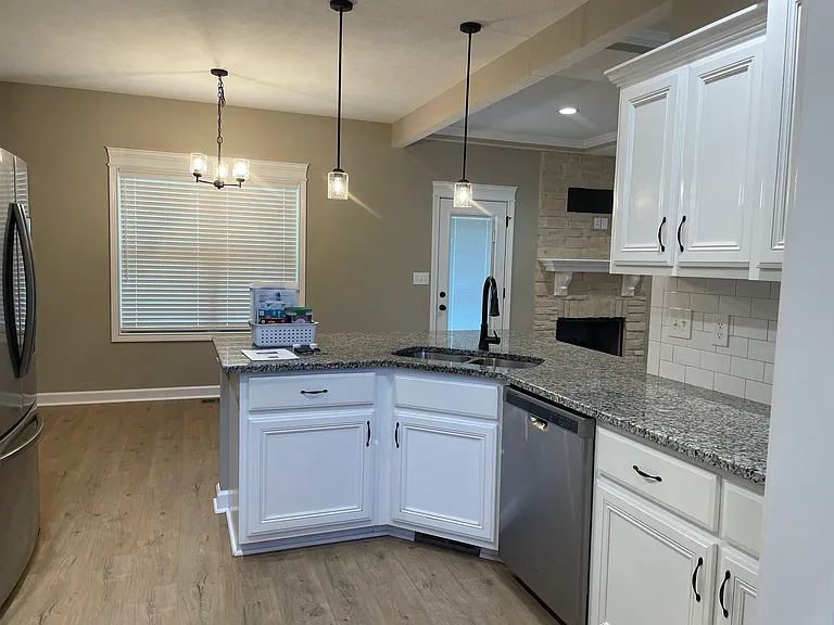Kitchen and a 4-stool bar top. Already installed dish washer, refrigerator, freezer, microwave and electric stove top.