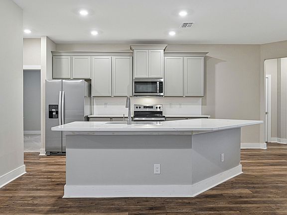The kitchen is chef-ready with stainless steel appliances