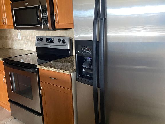 All stainless steel appliances with stone countertops and lots of cupboard space