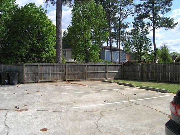 Parking area with privacy fence and yard