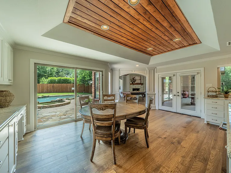 Dine in Style Under a Custom Wood Ceiling with Sparkling Pool Views